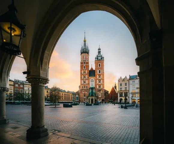 St Mary's Basilica framed by a stone archway in Kraków's Main Square