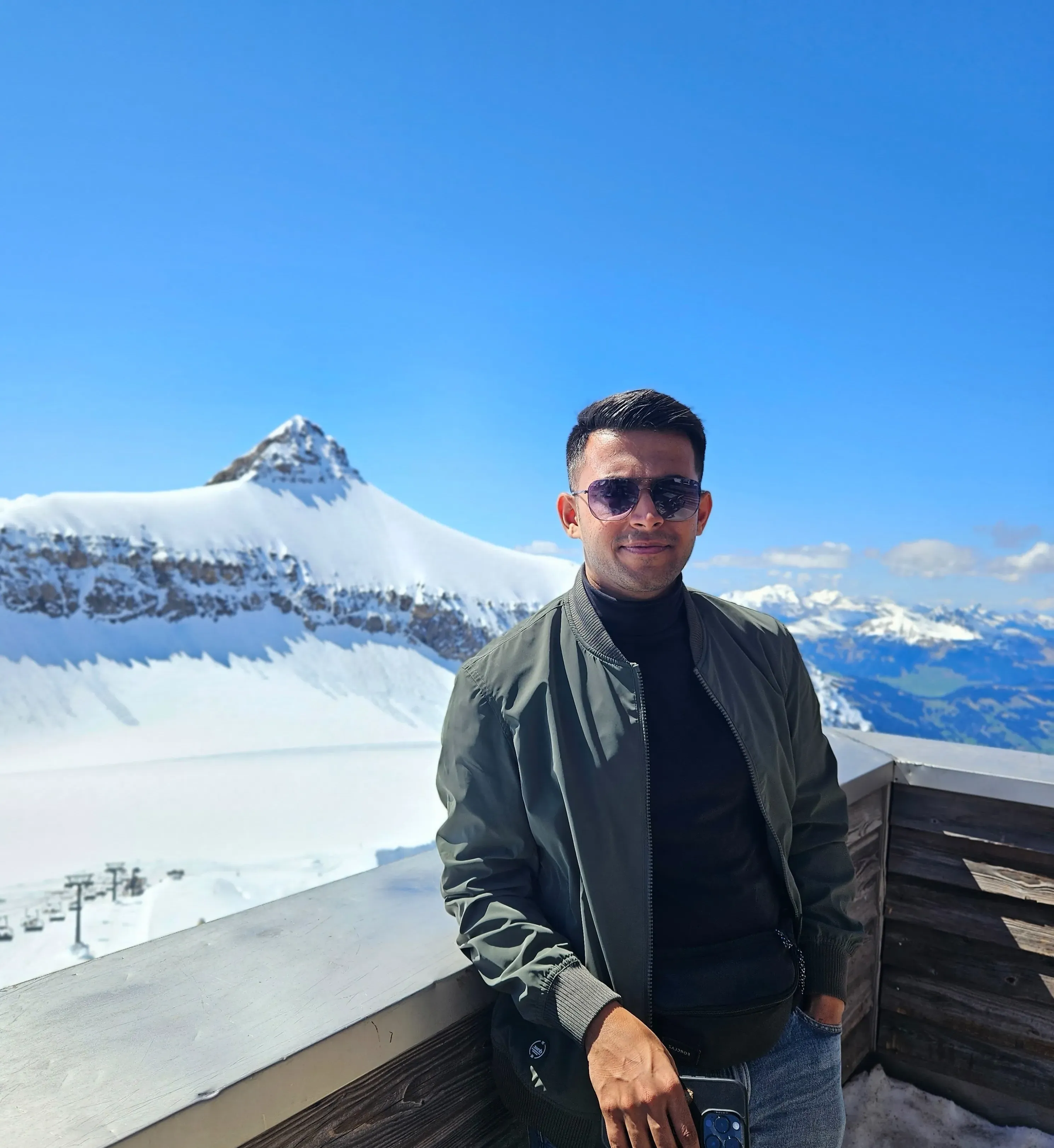 Aayush Shah at a snow-covered mountain viewpoint in the Swiss Alps